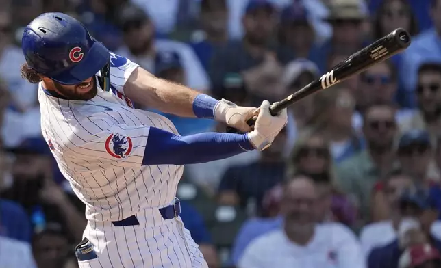 Chicago Cubs' Dansby Swanson hits a one-run single during the fifth inning of a baseball game against the Oakland Athletics in Chicago, Wednesday, Sept. 18, 2024. (AP Photo/Nam Y. Huh)