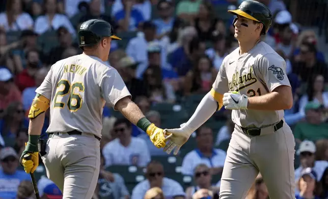 Oakland Athletics' Tyler Soderstrom, right, celebrates with Tyler Nevin after hitting a solo home run during the fourth inning of a baseball game against the Chicago Cubs in Chicago, Wednesday, Sept. 18, 2024. (AP Photo/Nam Y. Huh)