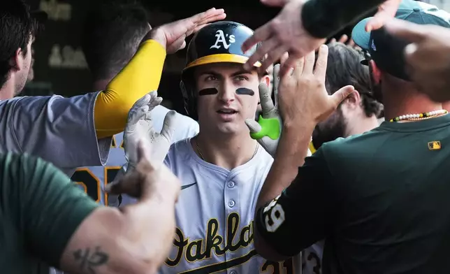 Oakland Athletics' Tyler Soderstrom celebrates with teammates after hitting a solo home run during the fourth inning of a baseball game against the Chicago Cubs in Chicago, Wednesday, Sept. 18, 2024. (AP Photo/Nam Y. Huh)