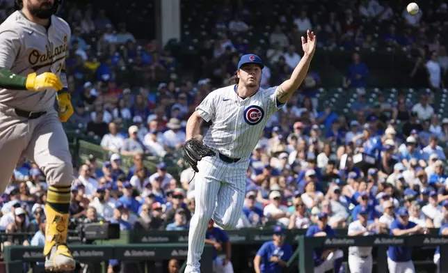 Chicago Cubs starting pitcher Justin Steele, right, throws out Oakland Athletics' Shea Langeliers at first during the first inning of a baseball game in Chicago, Wednesday, Sept. 18, 2024. (AP Photo/Nam Y. Huh)