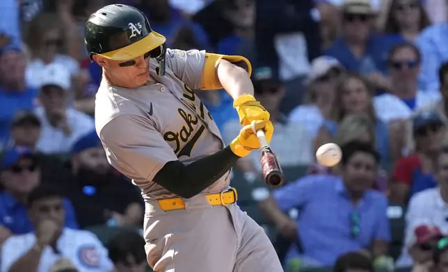 Oakland Athletics' Zack Gelof hits a one-run double during the eighth inning of a baseball game against the Chicago Cubs in Chicago, Wednesday, Sept. 18, 2024. (AP Photo/Nam Y. Huh)