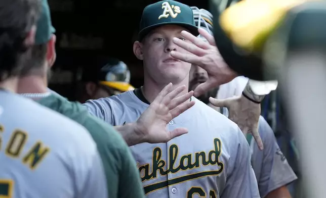 Oakland Athletics starting pitcher Brady Basso celebrates with teammates in the dugout after the third inning of a baseball game against the Chicago Cubs in Chicago, Wednesday, Sept. 18, 2024. (AP Photo/Nam Y. Huh)