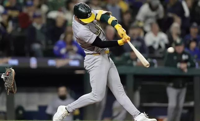 Oakland Athletics' Brent Rooker hits a two-run home run on a pitch from Seattle Mariners starting pitcher Emerson Hancock during the fifth inning in a baseball game, Saturday, Sept. 28, 2024, in Seattle. (AP Photo/John Froschauer)