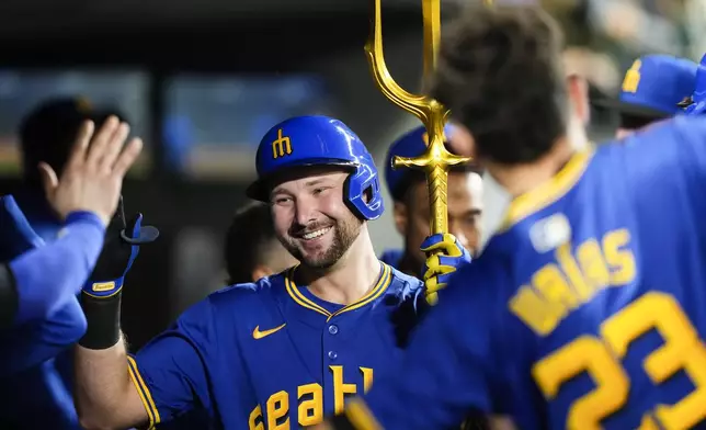 Seattle Mariners designated hitter Cal Raleigh celebrates his solo home run against the Oakland Athletics with teammates during the third inning of a baseball game, Friday, Sept. 27, 2024, in Seattle. (AP Photo/Lindsey Wasson)