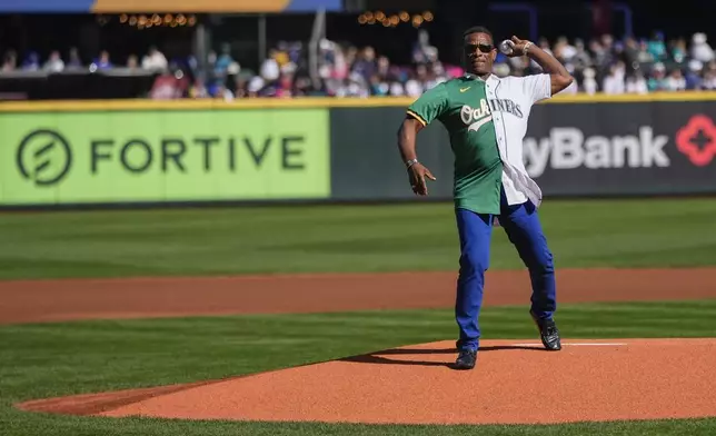 Former Seattle Mariners and Oakland Athletics player Rickey Henderson delivers the ceremonial first pitch before a baseball game between the Mariners and Athletics, Sunday, Sept. 29, 2024, in Seattle. (AP Photo/Lindsey Wasson)