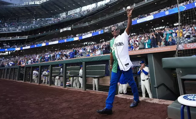 Former Seattle Mariners and Oakland Athletics player Rickey Henderson walks out to deliver the ceremonial first pitch before a baseball game between the Mariners and Athletics, Sunday, Sept. 29, 2024, in Seattle. (AP Photo/Lindsey Wasson)