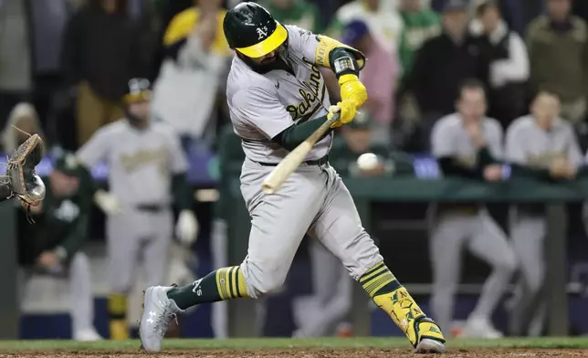 Oakland Athletics' Shea Langeliers hits a three-run home run on a pitch from Seattle Mariners pitcher Collin Snider during the ninth inning in a baseball game, Saturday, Sept. 28, 2024, in Seattle. (AP Photo/John Froschauer)