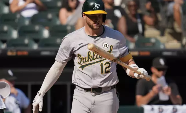 Oakland Athletics' Max Schuemann looks at his bat after striking out swinging during the ninth inning of a baseball game against the Chicago White Sox in Chicago, Sunday, Sept. 15, 2024. (AP Photo/Nam Y. Huh)