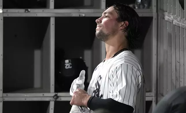 Chicago White Sox's Dominic Fletcher takes off his batting glove in the dugout after flying out in the seventh inning of a baseball game against the Oakland Athletics on Friday, Sept. 13, 2024, in Chicago. (AP Photo/Charles Rex Arbogast)