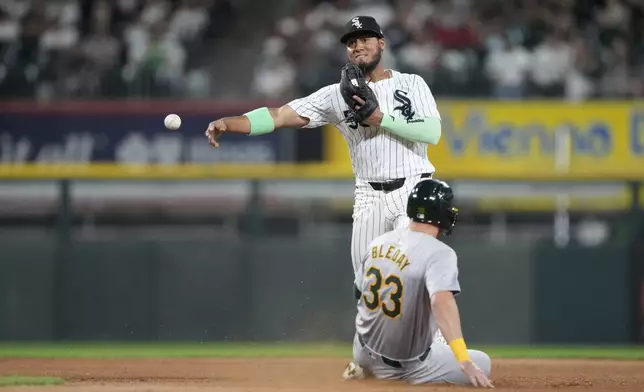 Chicago White Sox third base Lenyn Sosa throws to first after forcing Oakland Athletics' JJ Bleday out at second and gets Jacob Wilson at first to complete the double play during the sixth inning of a baseball game Friday, Sept. 13, 2024, in Chicago. (AP Photo/Charles Rex Arbogast)