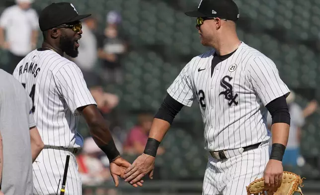 Chicago White Sox's Bryan Ramos, left, celebrates with Gavin Sheets after the White Sox defeated the Oakland Athletics in a baseball game in Chicago, Sunday, Sept. 15, 2024. (AP Photo/Nam Y. Huh)