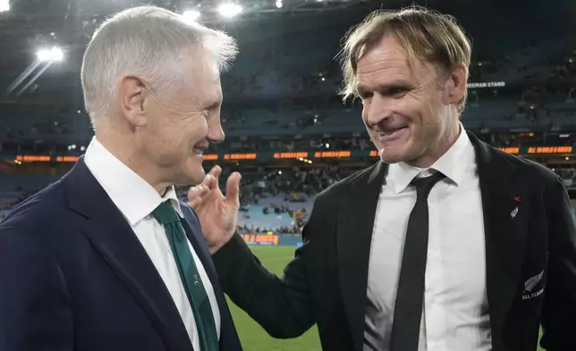 New Zealand's head coach Scott Robertson, right, chats with Australia's head coach Joe Schmidt after New Zealand won their rugby union test match in Sydney, Saturday, Sept. 21, 2024. (AP Photo/Rick Rycroft)