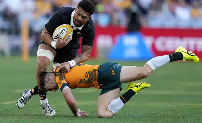 New Zealand's Ardie Savea, left, is tackled by Australia's Nic White during their rugby union test match in Sydney, Saturday, Sept. 21, 2024. (AP Photo/Rick Rycroft)