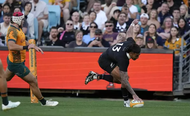 New Zealand's Rieko Ioane, Right, scores a try against Australia during their rugby union test match in Sydney, Saturday, Sept. 21, 2024. (AP Photo/Rick Rycroft)