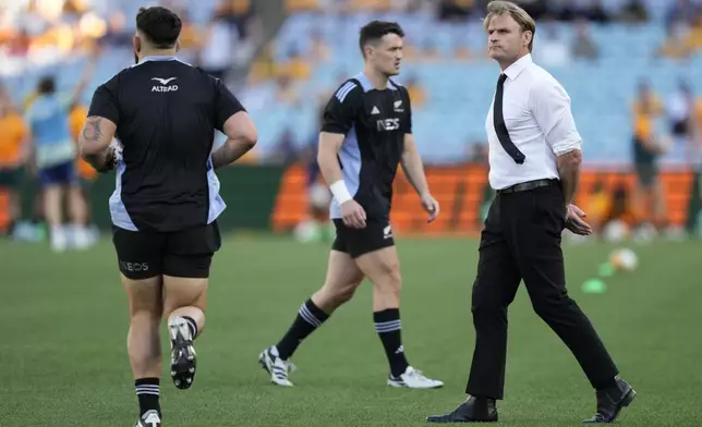 New Zealand's head coach Scott Robertson watches his team warm up before playing Australia in their rugby union test match in Sydney, Saturday, Sept. 21, 2024. (AP Photo/Rick Rycroft)