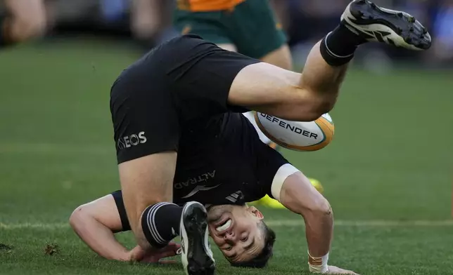 New Zealand's Will Jordan rolls after scoring a try against Australia during their rugby union test match in Sydney, Saturday, Sept. 21, 2024. (AP Photo/Rick Rycroft)