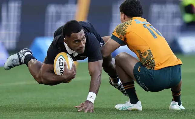 New Zealand's Sevu Reece, left, is tackled by Australia's Noah Lolesio during their rugby union test match in Sydney, Saturday, Sept. 21, 2024. (AP Photo/Rick Rycroft)