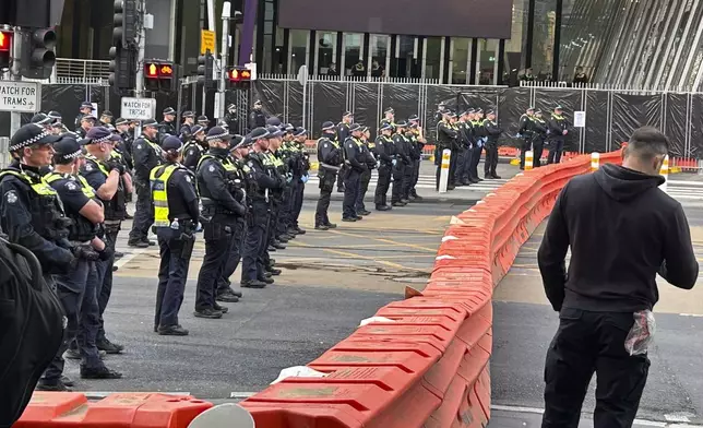 Victoria Police man barricades outside a military arms convention in downtown Melbourne, Australia, Wednesday, Sept. 11, 2024. (AP Photo/Rod McGuirk)