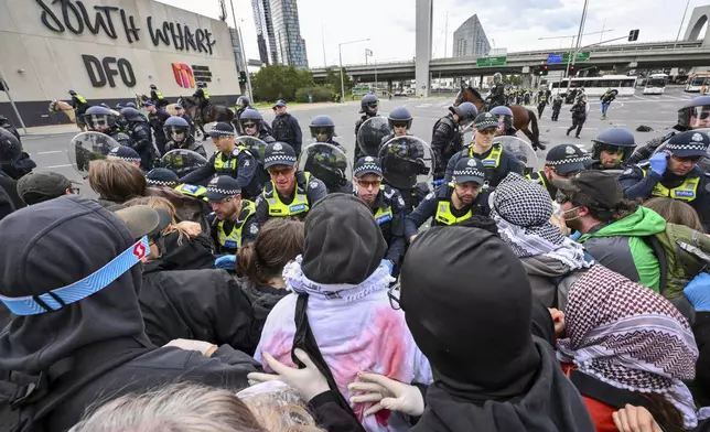 Victoria Police clash with anti-war protesters outside a military arms convention in downtown Melbourne, Australia,Wednesday, Sept. 11, 2024. (Joel Carrett/AAP Image via AP)