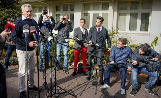 Austrian Chancellor Karl Nehammer speaks to media outside a polling station in Vienna, Austria, Sunday, Sept. 29, 2024, after casting his vote in the country's national election. (AP Photo/Andreea Alexandru)