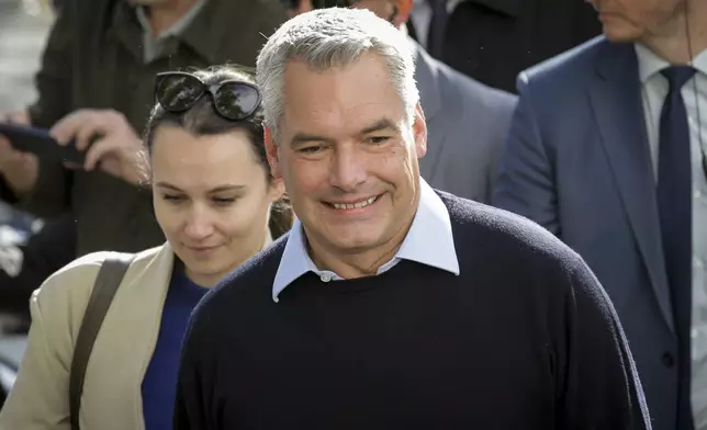 Austrian Chancellor Karl Nehammer arrives at a polling station in Vienna, Austria, Sunday, Sept. 29, 2024, to cast his vote in the country's national election. (AP Photo/Heinz-Peter Bader)