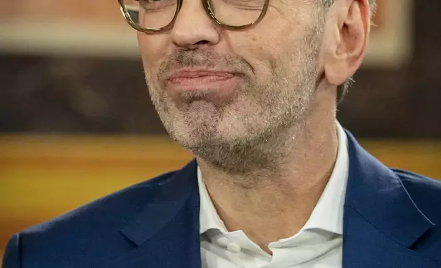 Herbert Kickl, leader of the Freedom Party of Austria smiles while standing at the national broadcaster studio, set up in the parliament building, in Vienna, Austria, Sunday, Sept. 29, 2024, after polls closed in the country's national election. (AP Photo/Andreea Alexandru)