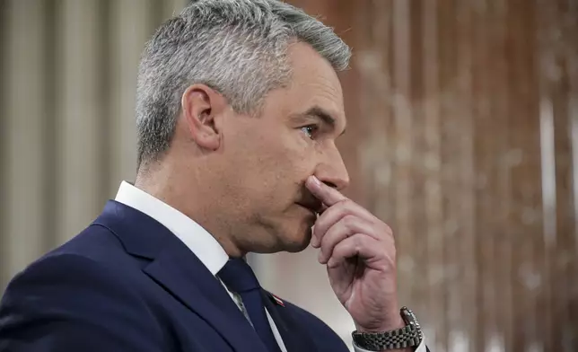 Austrian Chancellor Karl Nehammer gestures at the national broadcaster studio, set up in the parliament building, in Vienna, Austria, Sunday, Sept. 29, 2024, after polls closed in the country's national election. (AP Photo/Heinz-Peter Bader)