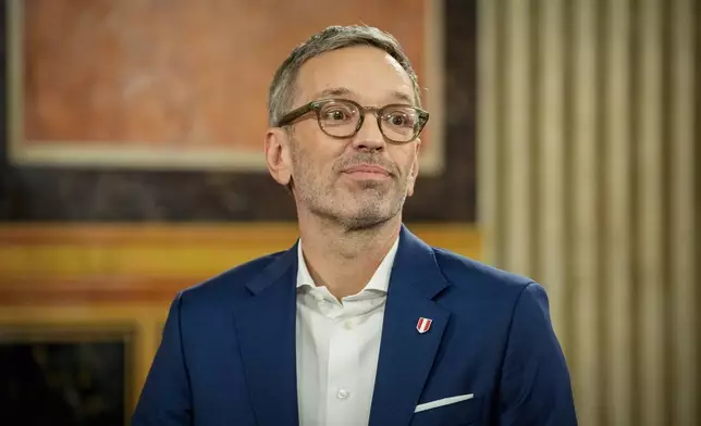 Herbert Kickl, leader of the Freedom Party of Austria smiles at the national broadcaster studio, set up in the parliament building, in Vienna, Austria, Sunday, Sept. 29, 2024, after polls closed in the country's national election. (AP Photo/Andreea Alexandru)