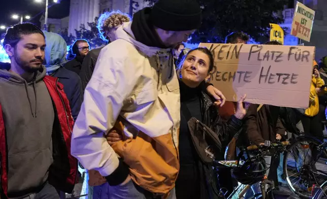 Anti right wing protesters hold a banner that reads "No room for right-wing agitation" as they walk near the parliament building, in Vienna, Austria, Sunday, Sept. 29, 2024, after polls closed in the country's national election. (AP Photo/Andreea Alexandru)