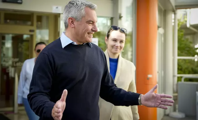 Austrian Chancellor Karl Nehammer smiles while leaving a polling station in Vienna, Austria, Sunday, Sept. 29, 2024, after casting his vote in the country's national election. (AP Photo/Andreea Alexandru)