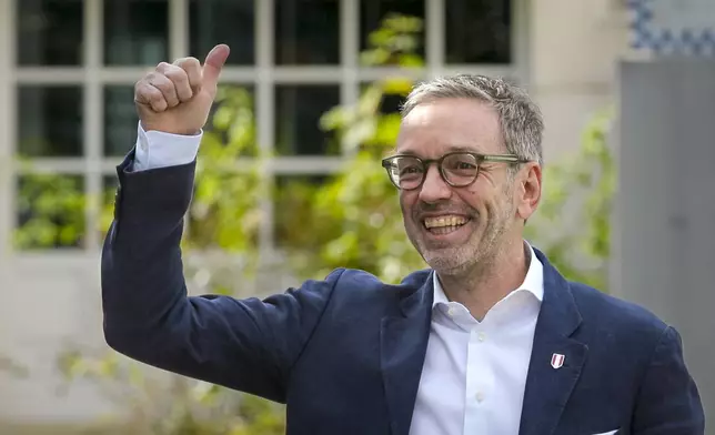 Herbert Kickl, leader of the Freedom Party of Austria gives a thumbs-up as he arrives at a polling station in Purkersdorf, Austria, Sunday, Sept. 29, 2024, to cast his vote in the country's national election. (AP Photo/Heinz-Peter Bader)