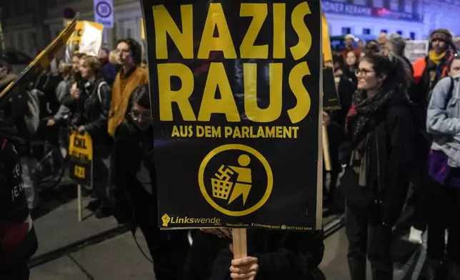 Anti right wing protesters shout slogans and hold banners that read "Nazis Out of the Parliament" outside the parliament building, in Vienna, Austria, Sunday, Sept. 29, 2024, after polls closed in the country's national election. (AP Photo/Andreea Alexandru)