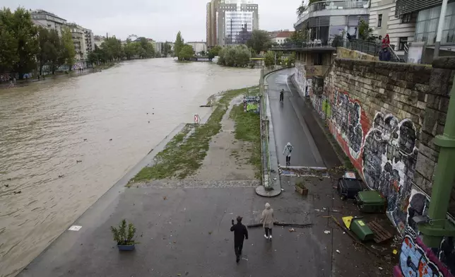 The Donaukanal channel floods its banks in central Vienna, Austria, Sunday, Sept. 15, 2024. (AP Photo/Heinz-Peter Bader)