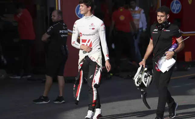 Haas driver Oliver Bearman of the United Kingdom walks through the pit lane during the Formula One Grand Prix qualifying in Baku, Azerbaijan, on Saturday, Sept. 14, 2024. (Ali Haideric/Pool via AP)