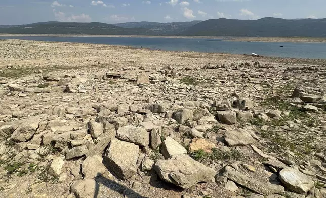 The dried up Bileca lake, near the town of Bileca, Bosnia, Thursday, Sept. 5, 2024. Experts say the summer of 2024 in the Balkans was the hottest since measurements started more than 130 years ago. (AP Photo/Eldar Emric)