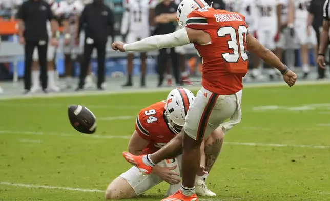 Miami place kicker Andres Borregales (30) kicks a field goal during the first half of an NCAA football game against Ball State, Saturday, Sept. 14, 2024, in Miami Gardens, Fla. (AP Photo/Lynne Sladky)