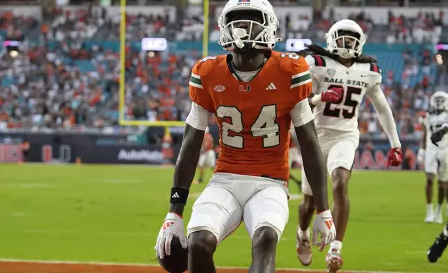 Miami running back Chris Johnson Jr. (24) scores a touchdown during the first half of an NCAA football game against against Ball State, Saturday, Sept. 14, 2024, in Miami Gardens, Fla. (AP Photo/Lynne Sladky)