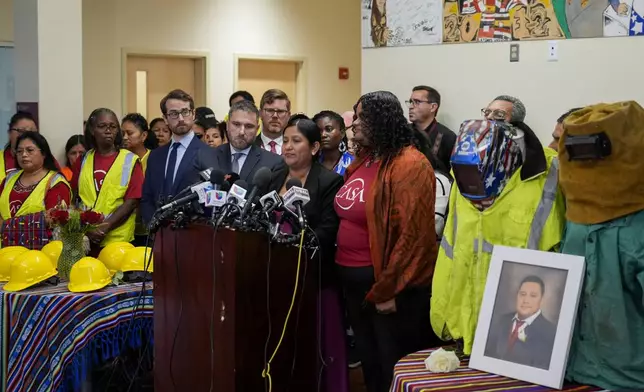 Maria del Carmen Castellón, center, the wife of Miguel Luna, a welder who died during the collapse of Baltimore's Francis Scott Key Bridge, speaks during a press conference, Tuesday, Sept. 17, 2024, in Baltimore. (AP Photo/Stephanie Scarbrough)