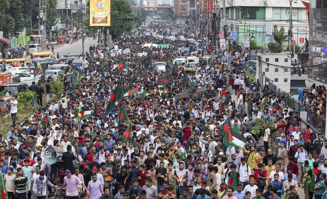 Students and other activists carry Bangladesh's national flag during a protest march organized by Students Against Discrimination to mark one month since former Prime Minister Sheikh Hasina stepped down after a mass uprising, in Dhaka, Bangladesh, Thursday, Sept. 5, 2024. (AP Photo/Rajib Dhar)