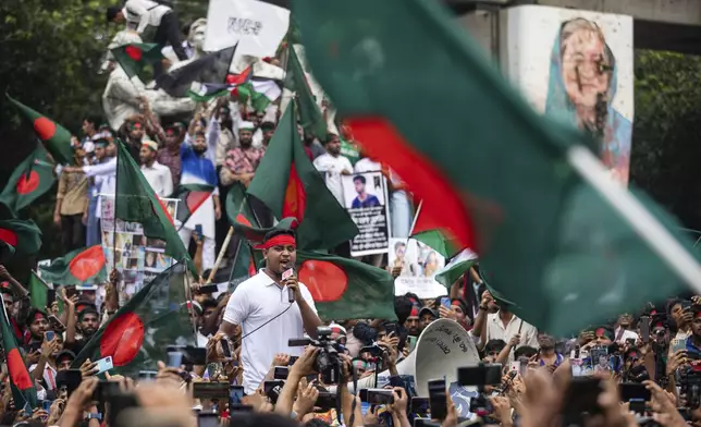 Students and other activists carry Bangladesh's national flag during a protest march organized by Students Against Discrimination to mark one month since former Prime Minister Sheikh Hasina stepped down after a mass uprising, in Dhaka, Bangladesh, Thursday, Sept. 5, 2024. (AP Photo/Rajib Dhar)