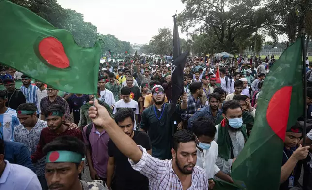 Students and other activists carry Bangladesh's national flag during a protest march organized by Students Against Discrimination to mark one month since former Prime Minister Sheikh Hasina stepped down after a mass uprising, in Dhaka, Bangladesh, Thursday, Sept. 5, 2024. (AP Photo/Rajib Dhar)