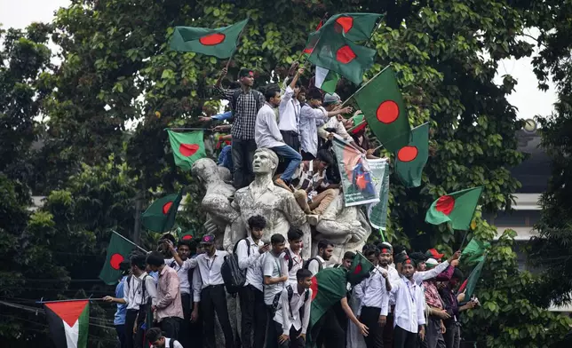 Students and other activists carry Bangladesh's national flag during a protest march organized by Students Against Discrimination to mark one month since former Prime Minister Sheikh Hasina stepped down after a mass uprising, in Dhaka, Bangladesh, Thursday, Sept. 5, 2024. (AP Photo/Rajib Dhar)