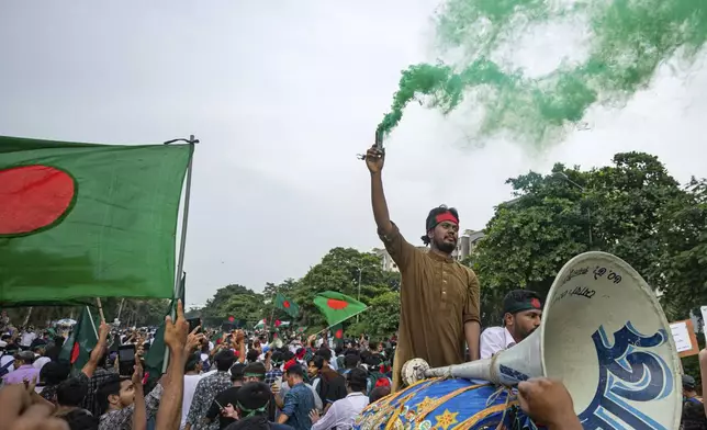 Students and other activists carry Bangladesh's national flag during a protest march organized by Students Against Discrimination to mark one month since former Prime Minister Sheikh Hasina stepped down after a mass uprising, in Dhaka, Bangladesh, Thursday, Sept. 5, 2024. (AP Photo/Rajib Dhar)