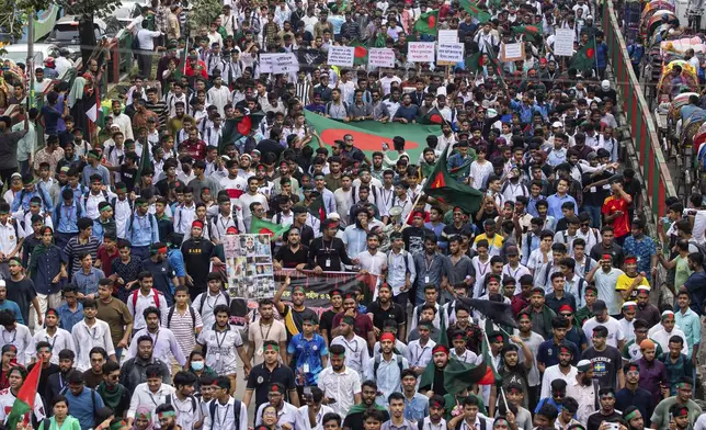 Students and other activists carry Bangladesh's national flag during a protest march organized by Students Against Discrimination to mark one month since former Prime Minister Sheikh Hasina stepped down after a mass uprising, in Dhaka, Bangladesh, Thursday, Sept. 5, 2024. (AP Photo/Rajib Dhar)