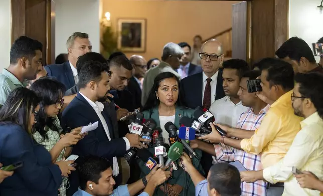 Anjali Kaur, Deputy Assistant Administrator of the Bureau for Asia, United States Agency for International Development (USAID), center, speaks to media personnel after the signing of the 6th amendment of 'The Development Objective Grant Agreement (DOAG)' between US and Bangladesh, in Dhaka, Bangladesh, Sunday, Sept. 15, 2024. (AP Photo/Rajib Dhar)