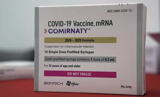 A box of COVID-19 vaccines is displayed at a pharmacy in New York, Tuesday, Sept. 24, 2024. (AP Photo/Mary Conlon)