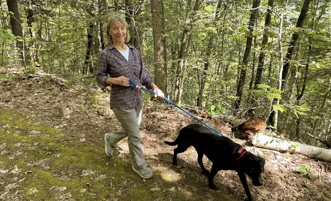 Susannah Johnston, of Croton-on-Hudson, N.Y., walks her dog Ellie on Sept. 8, 2024 in Norfolk, Conn. Johnston, a fit yoga instructor and strength trainer, has been injured three times in incidents involving walking her dog. (Vincent Cohan via AP)