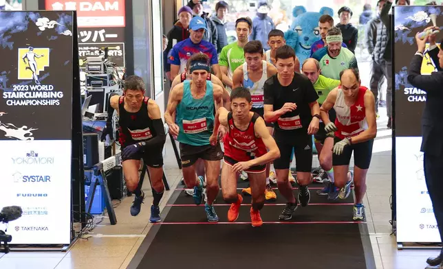 In this photo provided by ISF/Meeting, competitors start a race of Stairclimbing World Championships in Osaka, western Japan, Nov. 19, 2023. (ISF/MEETING via AP)