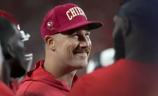 Kansas City Chiefs tight end Travis Kelce smiles on the sidelines during the first half of an NFL preseason football game against the Chicago Bears Thursday, Aug. 22, 2024, in Kansas City, Mo. (AP Photo/Ed Zurga)