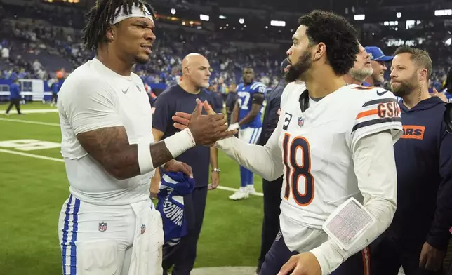 Indianapolis Colts quarterback Anthony Richardson, left, and Chicago Bears quarterback Caleb Williams (18) greet following an NFL football game Sunday, Sept. 22, 2024, in Indianapolis. (AP Photo/Michael Conroy)